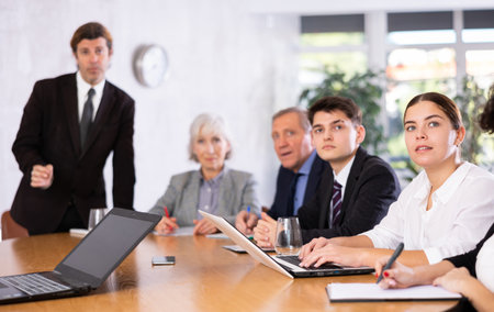 Successful businessman tells his colleagues the presentation and future plans of companyの写真素材