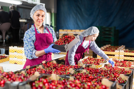 Women in cherry warehouseの写真素材