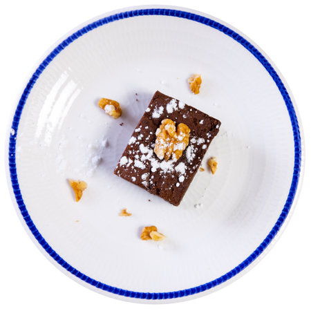 Piece of chocolate pie brownie with walnuts and powdered sugarの写真素材