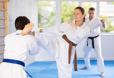 Man and woman train to perform basic defensive attacking actions during mortal techniques classes