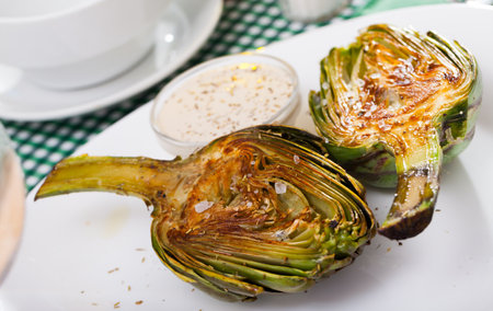 Artichokes with salt and sauceの写真素材