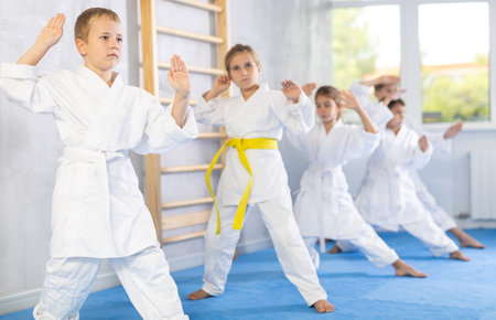 Young karate students gather in dojoの写真素材
