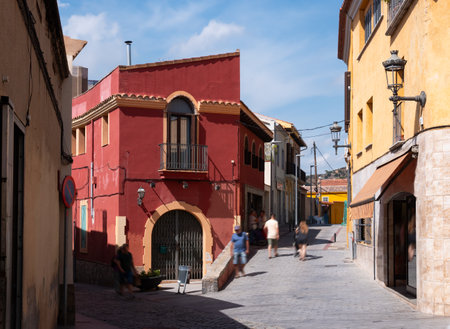 Low houses and residential buildings on central street of medieval city of Santa Coloma de Gramenetの写真素材