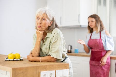 Aggrieved elderly woman having quarrel with her daughterの写真素材