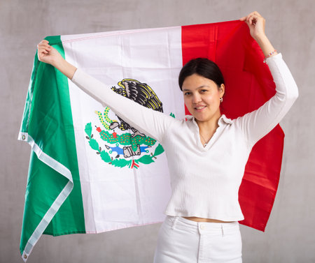 Young woman posing in studio with Mexico flagの写真素材