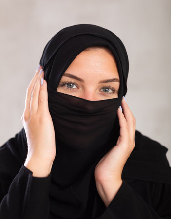 Young woman dressed in traditional islamic clothes with her face coveredの写真素材