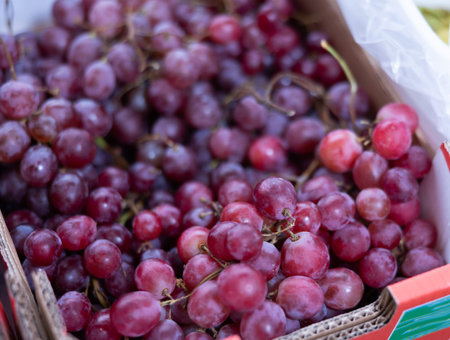 Bunch of grapes lies on counter in shop