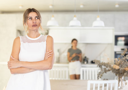 Domestic quarrel - two sisters have quarreled, and they are talking to each otherの写真素材