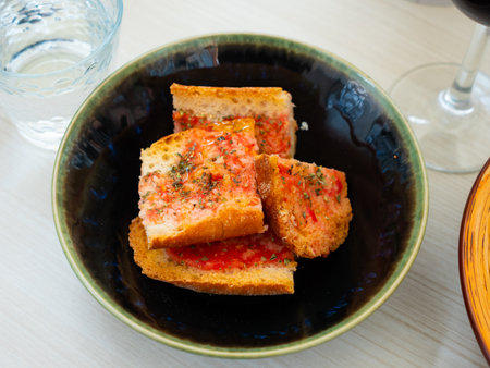 Pieces of bread rubbed with tomato and garlic, pa amb tomaquetの写真素材