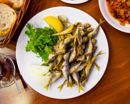 Delicious fried red mullet fish with parsley and lemonの写真素材