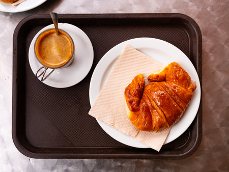 Fresh crisp delicious French croissant with cup of fragrant coffeeの写真素材