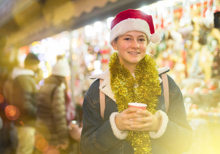 Young girl in santa hat at new years fairの写真素材