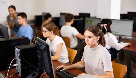 Teenager girl using PC during computer science lessonの写真素材