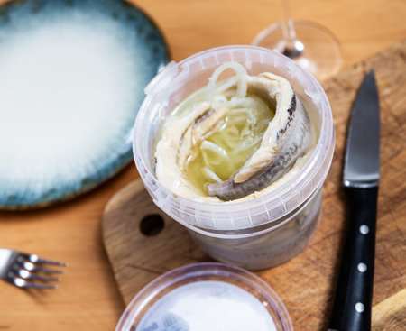 In plastic bucket containers are large pieces of salted herring fillet, freed from bonesの写真素材