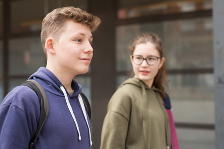 Portrait of two teenage friends chatting outdoorsの写真素材