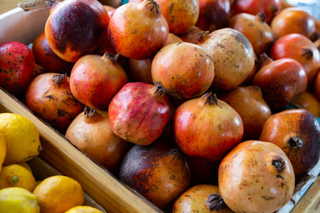 Fresh ripe pomegranates on the counter market. Grenades on counter for saleの写真素材
