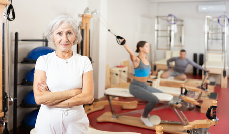 Elderly woman posing in pilates studioの写真素材