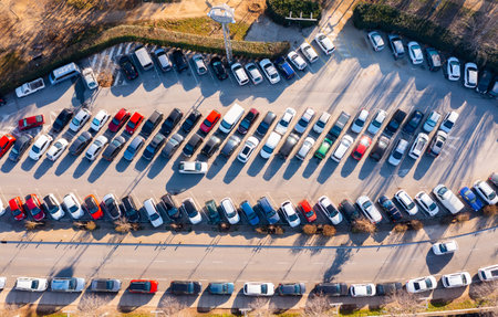 Top down view paved outdoor parking with filled with cars