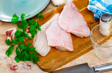 Raw rockfish fillet with condiments, food preparationの写真素材