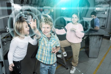 Little girl yelling at boy reaching for something in quest room, toned imageの写真素材