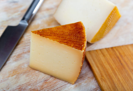 Traditional Spanish cheese - with ivory color and small irregular holes closeup