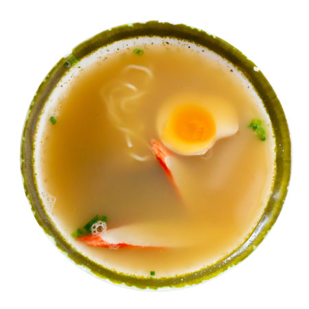 Traditional japanese noodle soup with mushroom, egg and greens served in bowl