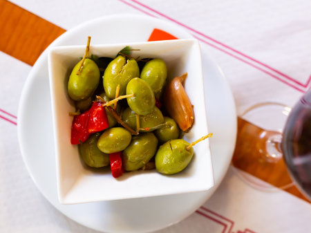 Green olives served with pepper and garlicの写真素材