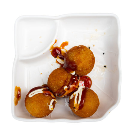 Takoyaki balls served in a plate with soya sauce