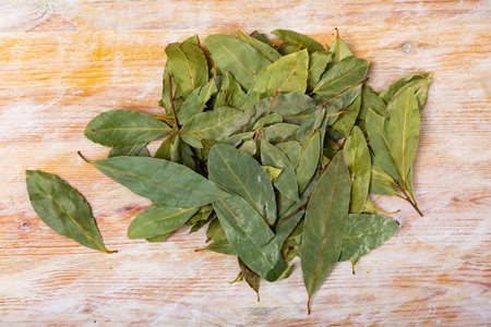 Pile of dried bay leaves lie on table