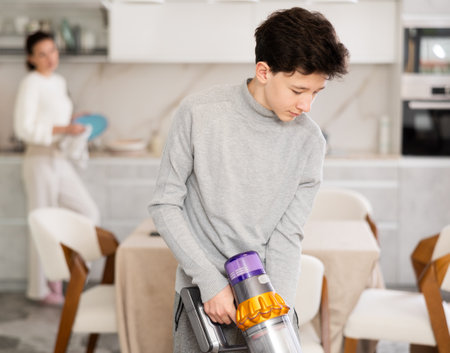 Son doing household choresの写真素材