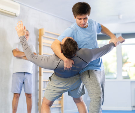 Adult and young men training self-defense techniquesの写真素材