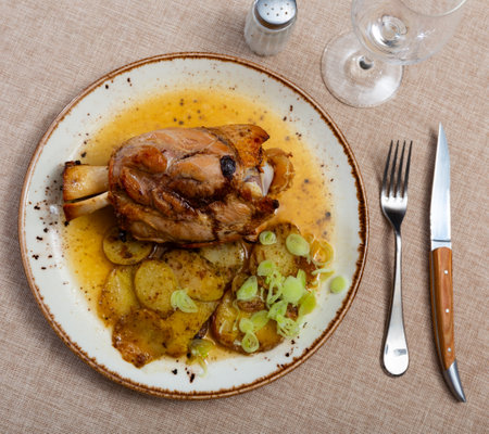 Stewed knuckle with potato served in a plateの写真素材