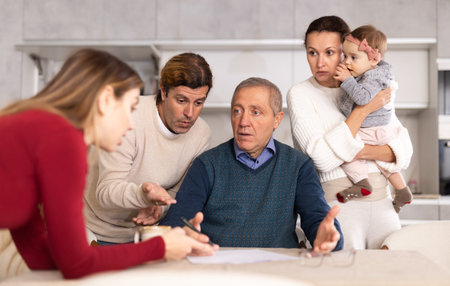 Family of different ages arguing while filling out important documents