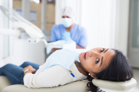 Professional doctor man talking with patient in chairの写真素材
