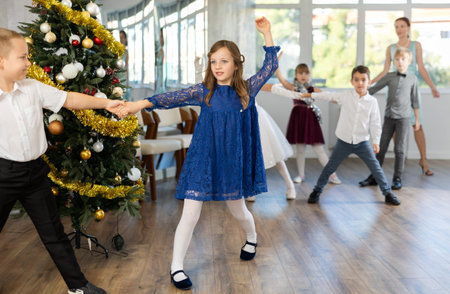 Tween girl practicing partner jive in Christmas dance studio