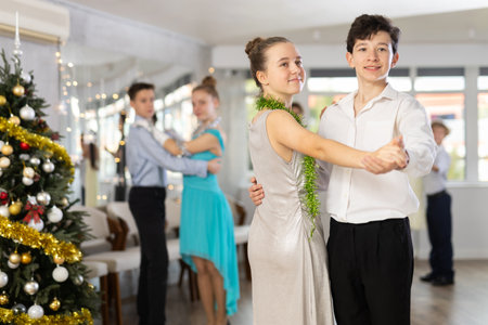 Boy and girl dancing waltz in studioの写真素材