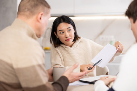 Couple young woman and guy discussing deal with agentの写真素材