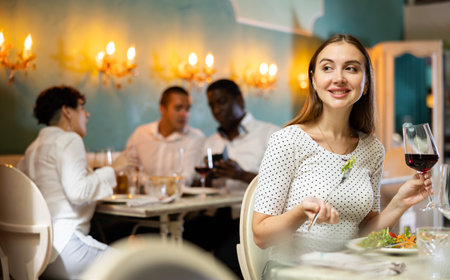 Girl sitting in restaurantの写真素材