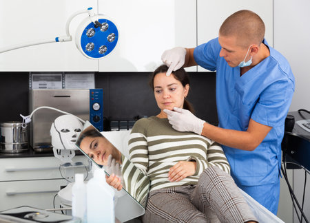 Woman having consultation with doctor in clinicの写真素材