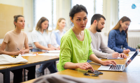 Woman using laptop during lesson in universityの写真素材