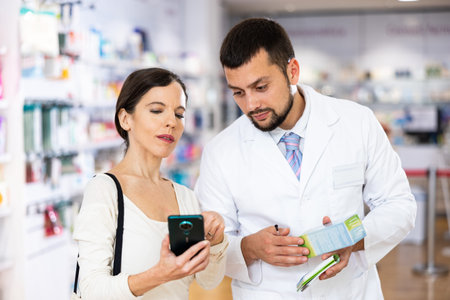 Woman with smartphone having conversation with apothecary