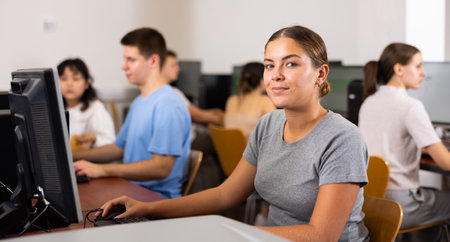 Female teacher working on computer in school classの写真素材