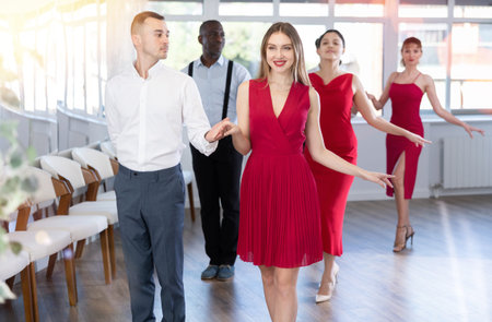 Couples of men and women dancing waltz