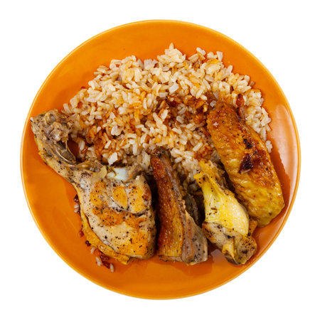 Baked chicken thighs served with rice on plateの写真素材