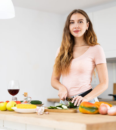 Confident young woman cooking lunch in the kitchenの写真素材