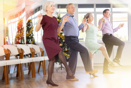 View of senior people holding hands and dancing national dance Sardana during celebration Christmas
