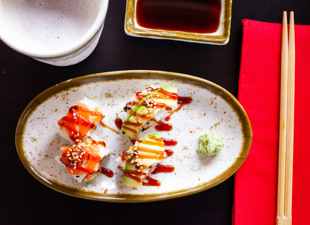 Uramaki with salmon, avocado, unagi sauce and sesameの写真素材