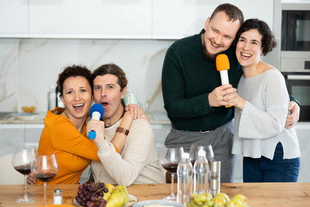 Party and karaoke at house for fun social event or gathering together in celebration.の写真素材