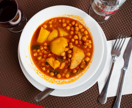 Stew boiled soup prepare of cod fillet, potatoes, chickpeas in tomato sauce.の写真素材