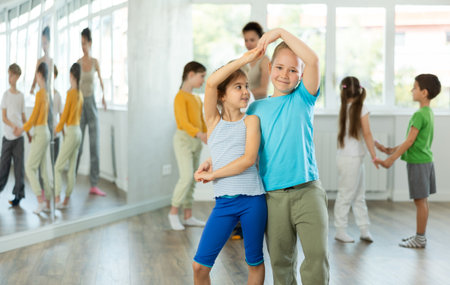 Preteen girls and boys learn to dance classical dances in choreographic studioの写真素材